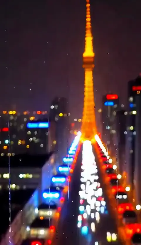 Vertical shot of neon rain falling past a Tokyo window